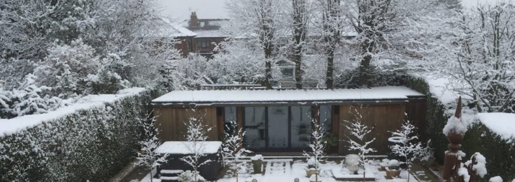 An image of a garden office in a snowy winter setting